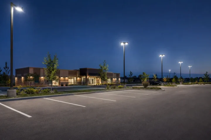 Commercial parking lot at dusk with LED pole lighting