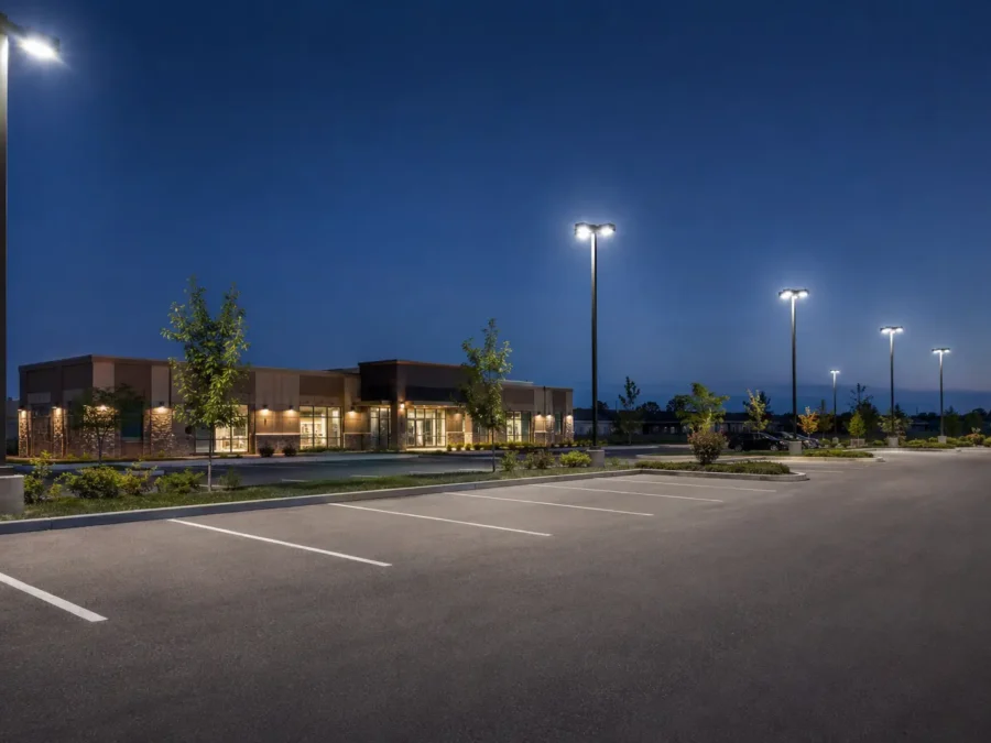 Commercial parking lot at dusk with LED pole lighting